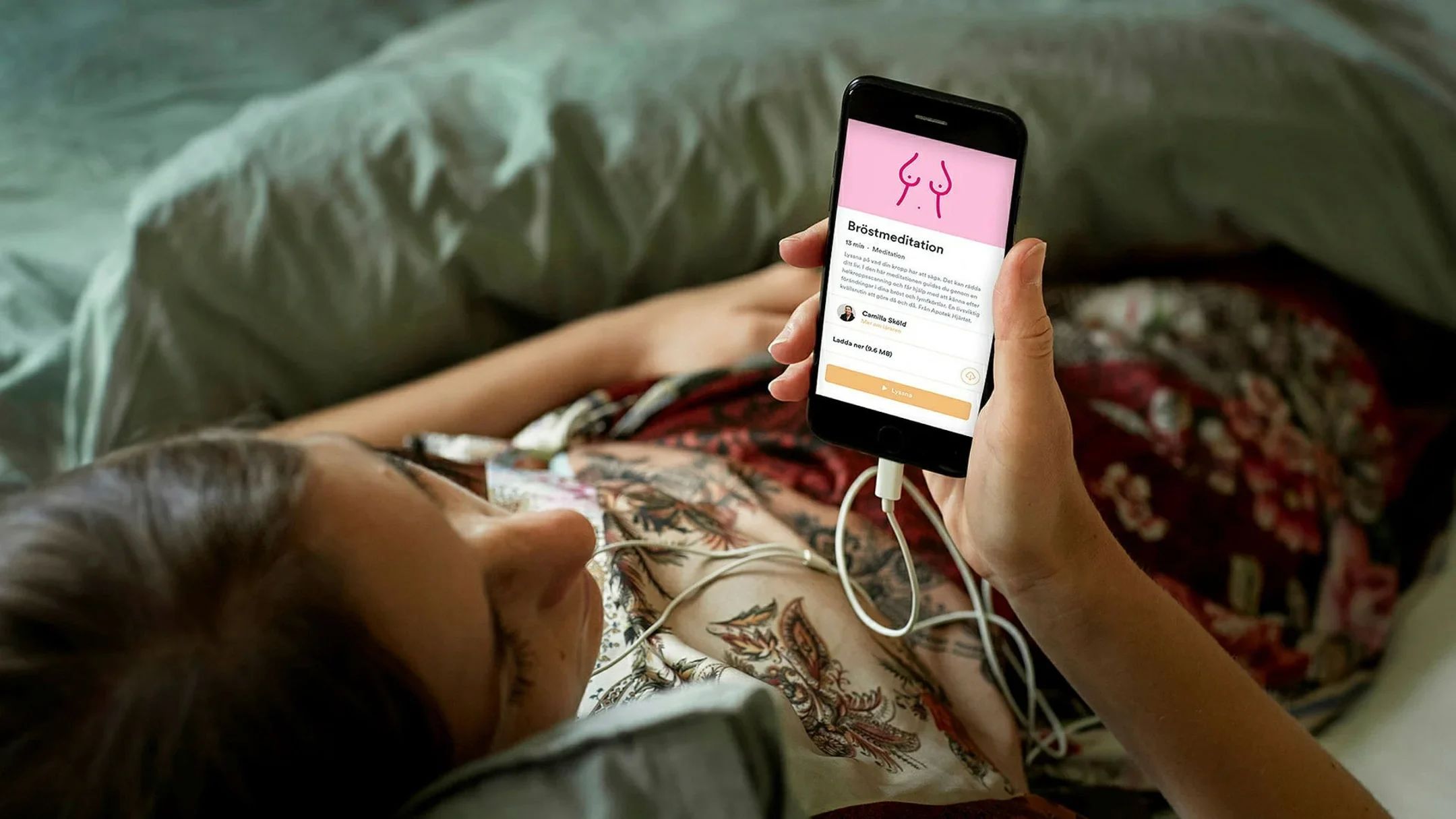 A young woman reads a health article on her smartphone screen.