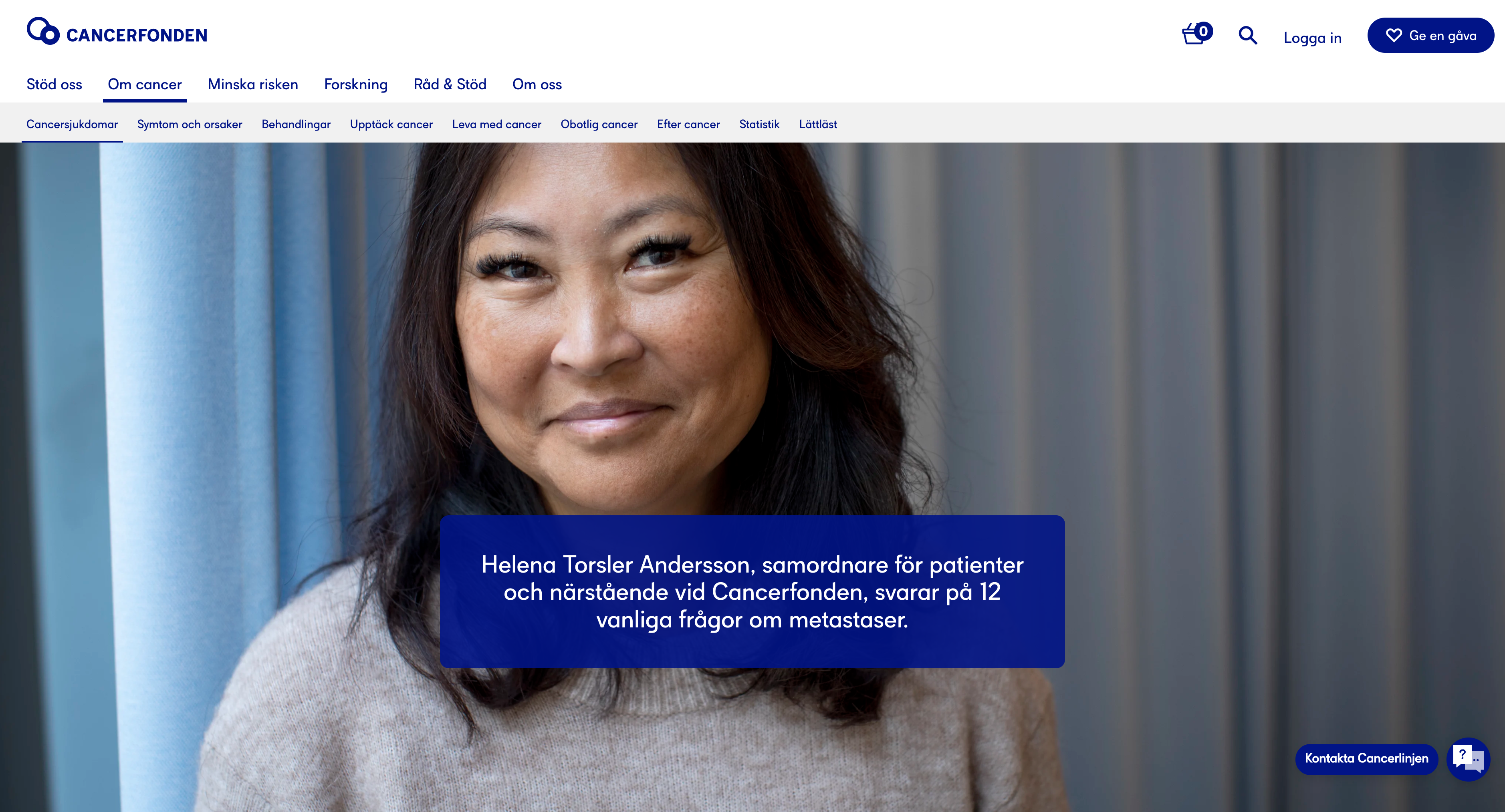 A woman with tan skin and black hair stands in front of a hospital curtain.