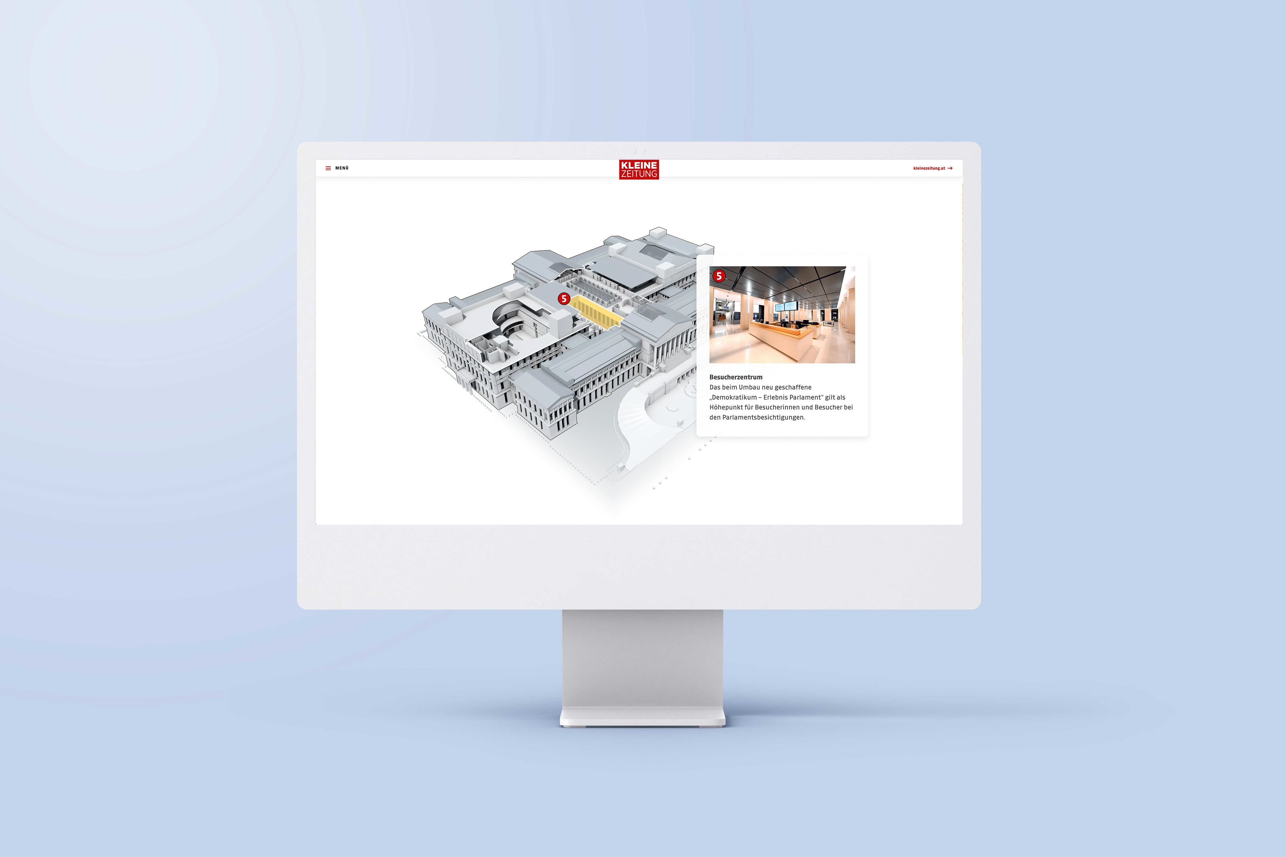 An image of a computer screen sitting on a desk. The screen is showing an example of an interactive map in the article 'A detailed look inside the Austrian Parliament'.