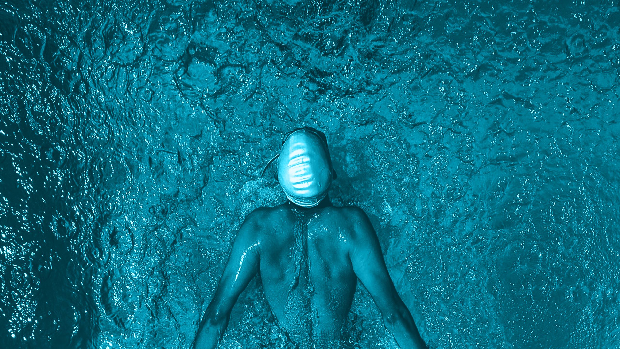 A swimmer mid-way through a butterfly stroke