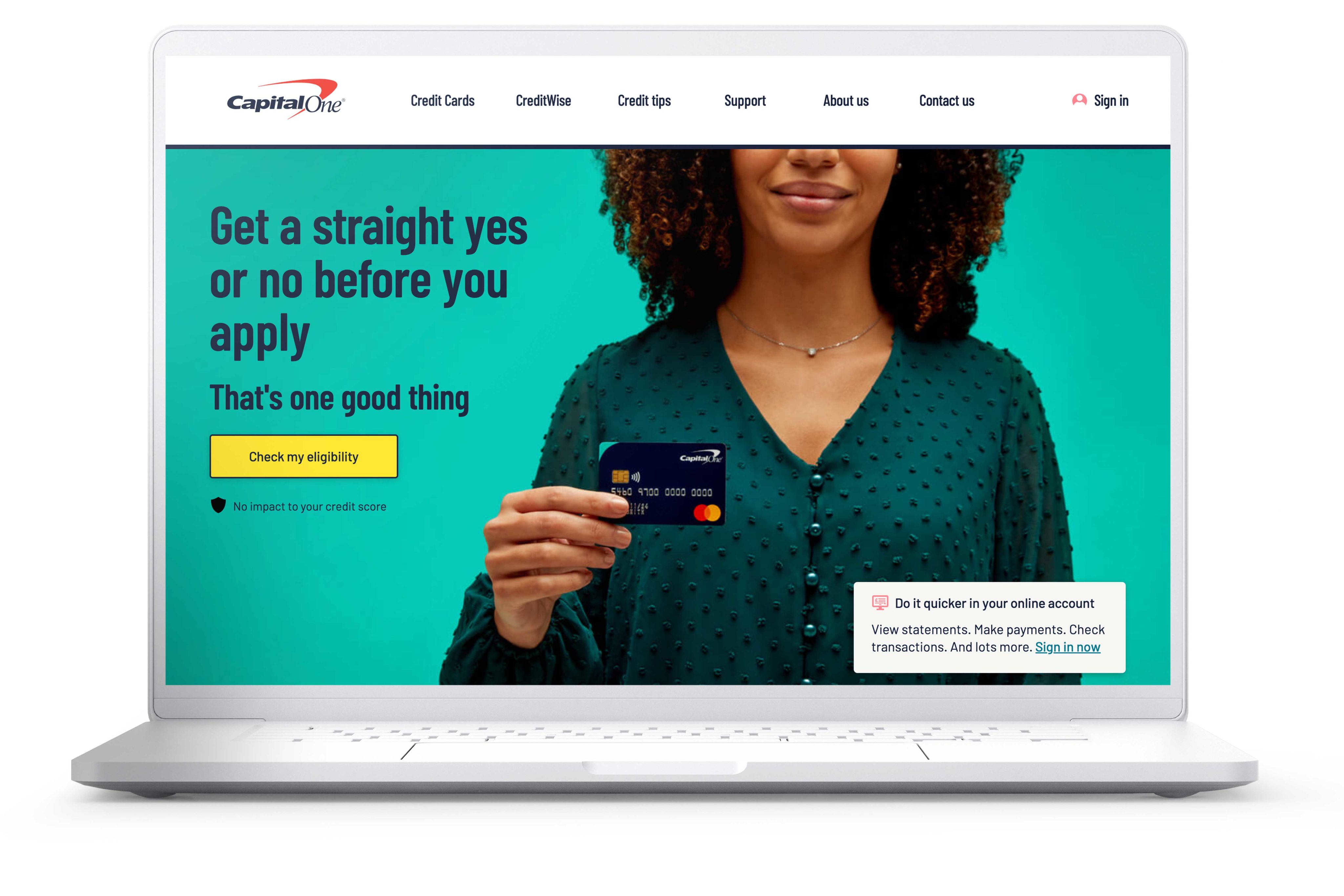 A laptop screen showing the homepage of the CapitalOne website.