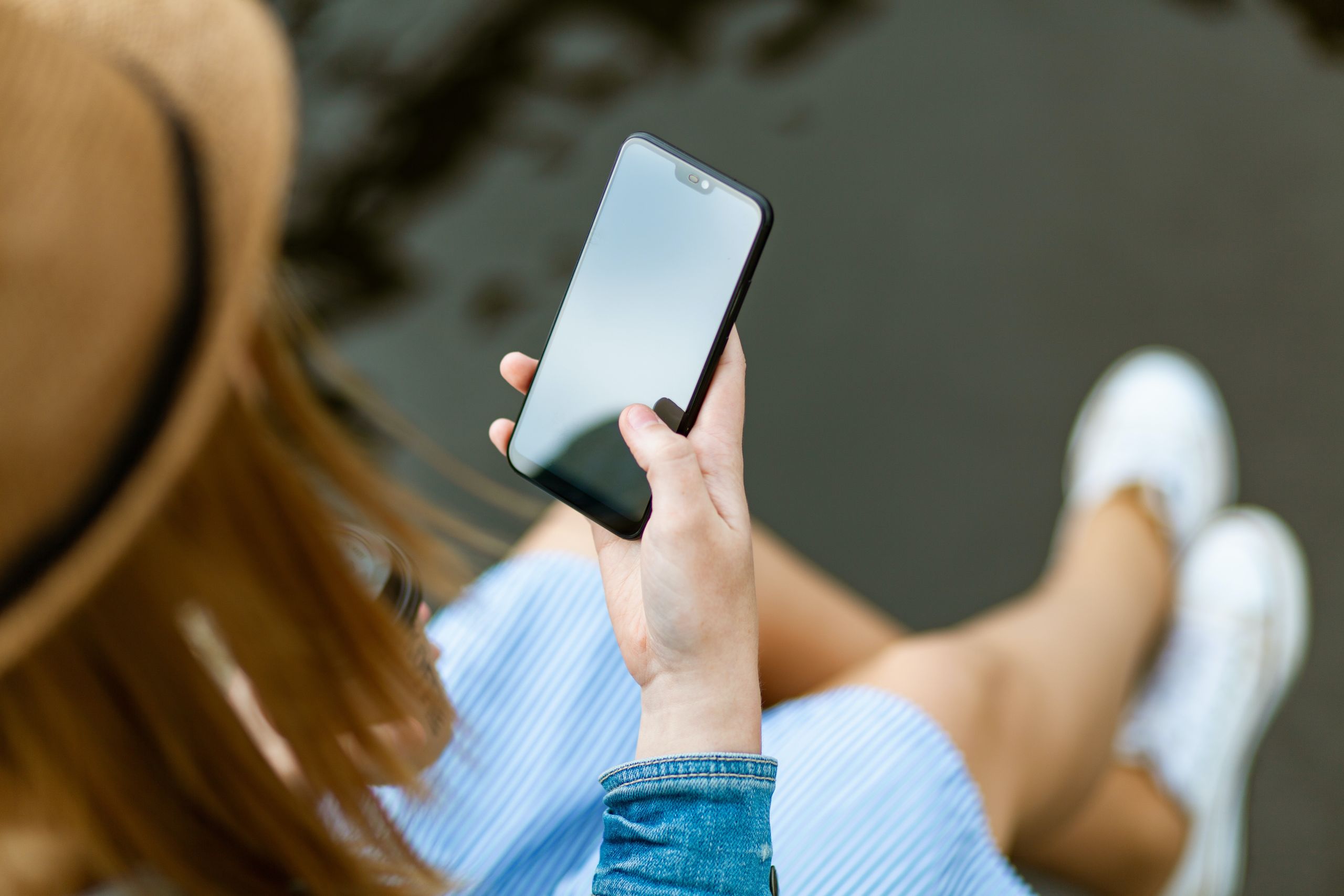 Woman looking at smartphone, potentially showing a Google Web Story