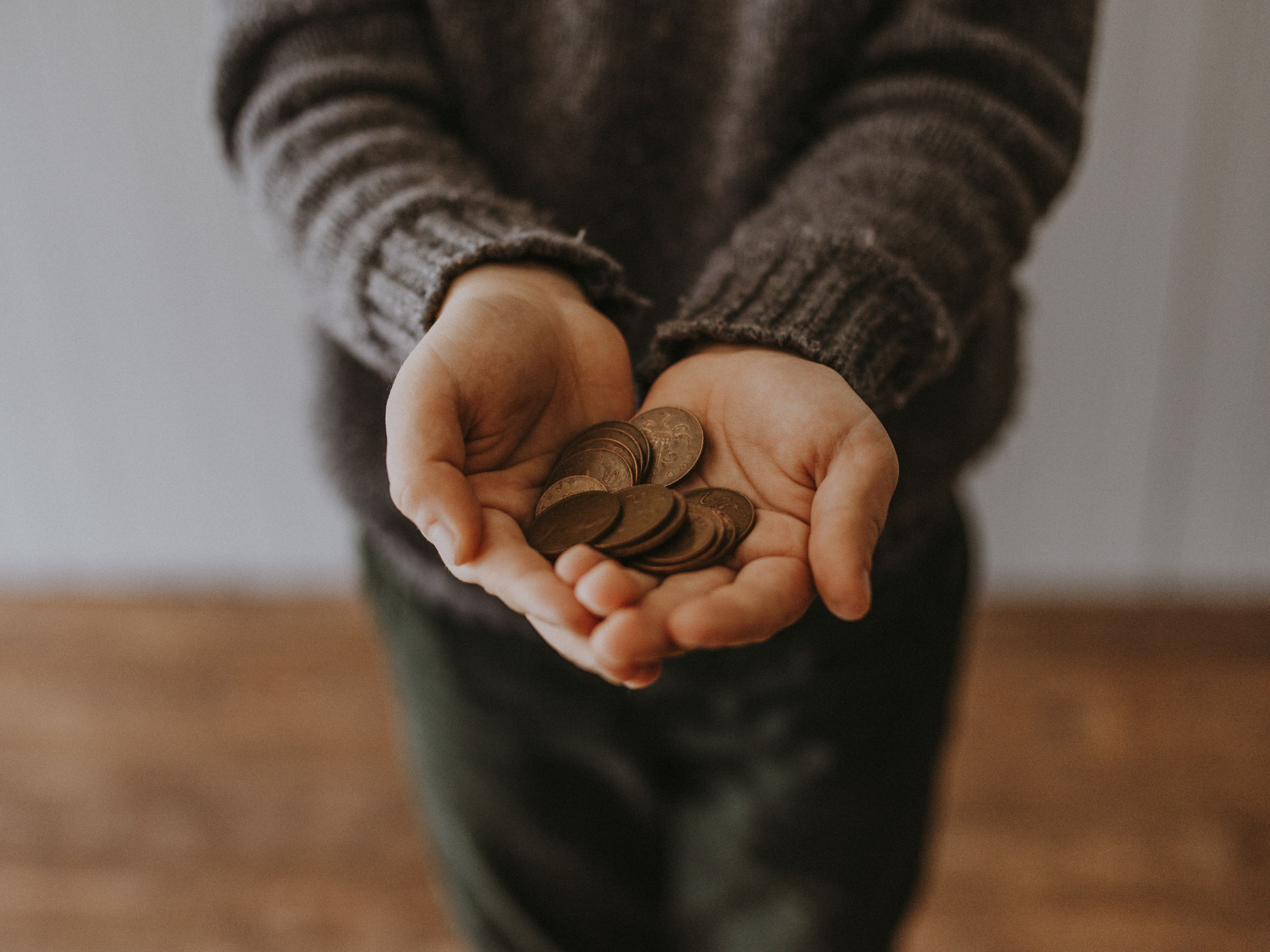 Copper-coloured coins in a person's hands