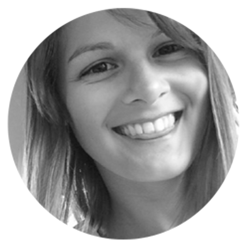 A black and white photo of a smiling person.