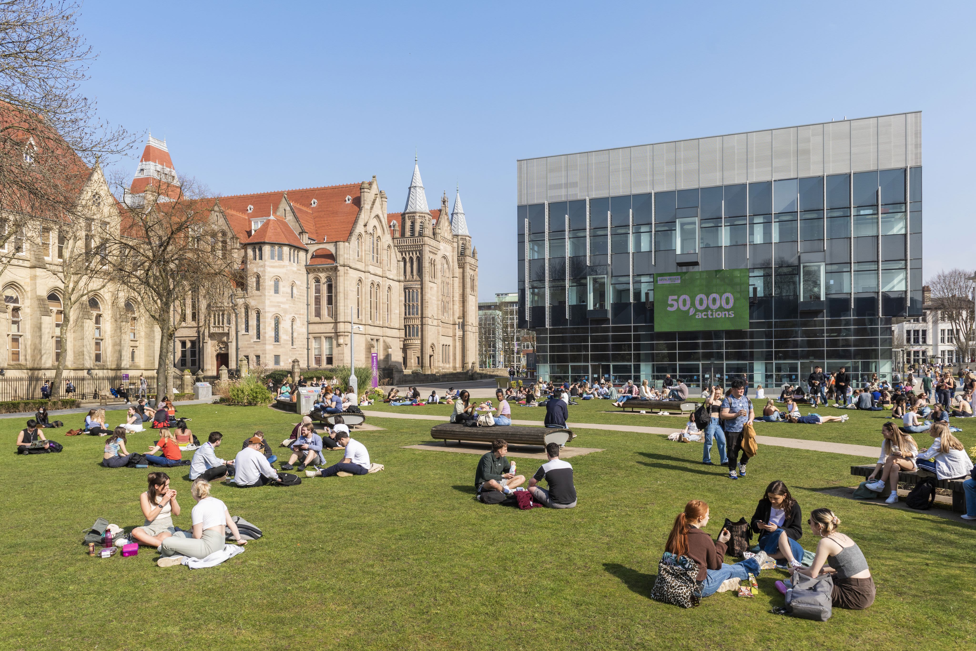 Students picnic on a university lawn.