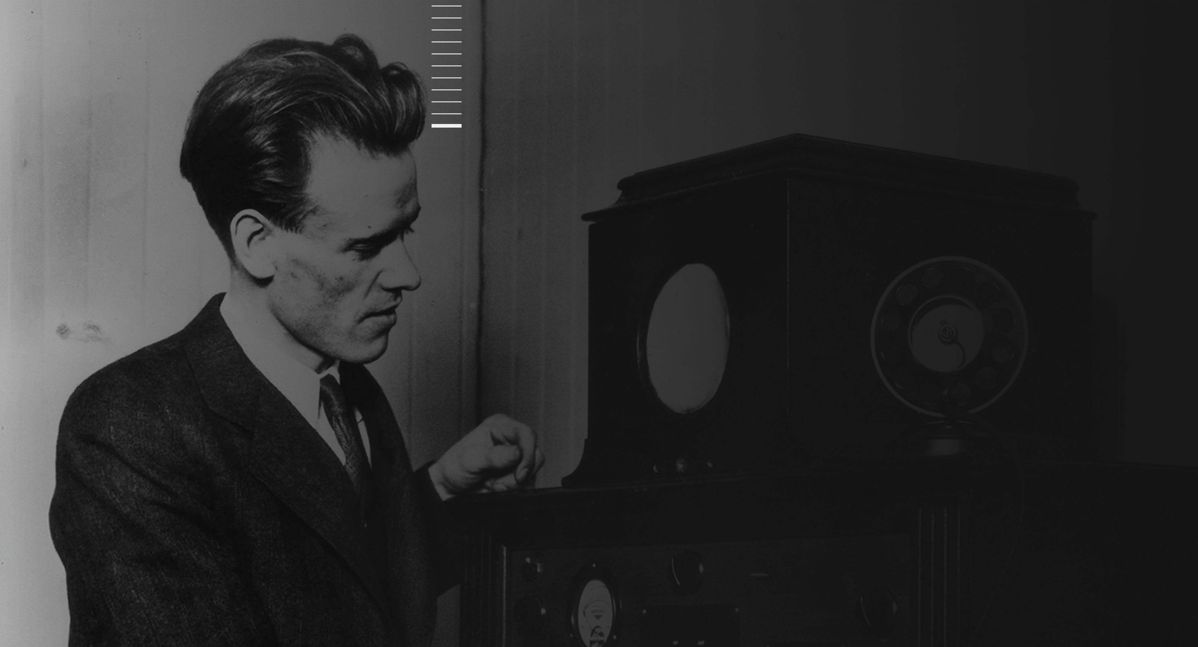 Inventor stands with early television.