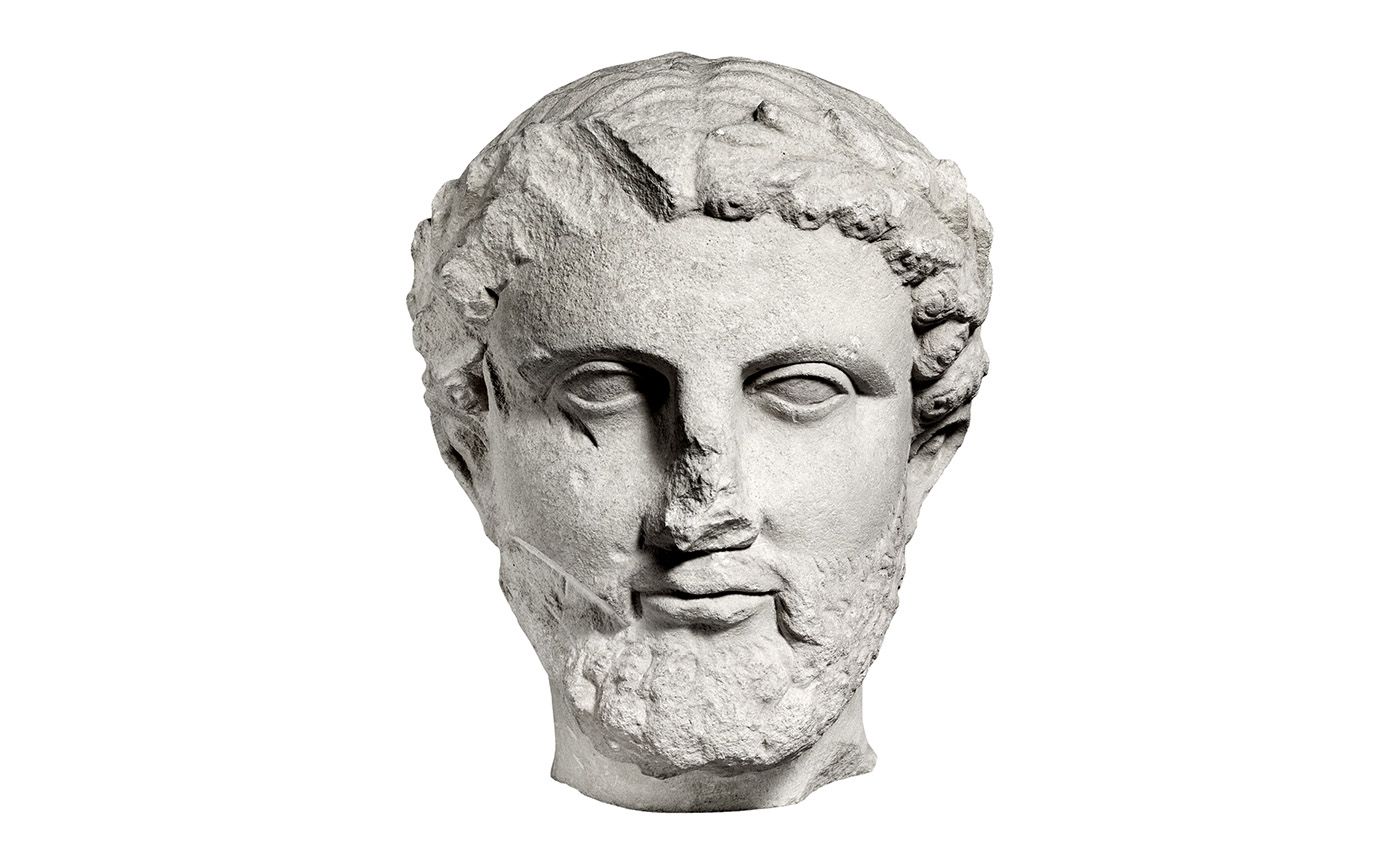 Antique classic greek philosopher head, limestone bearded man head with a wreath of leaves