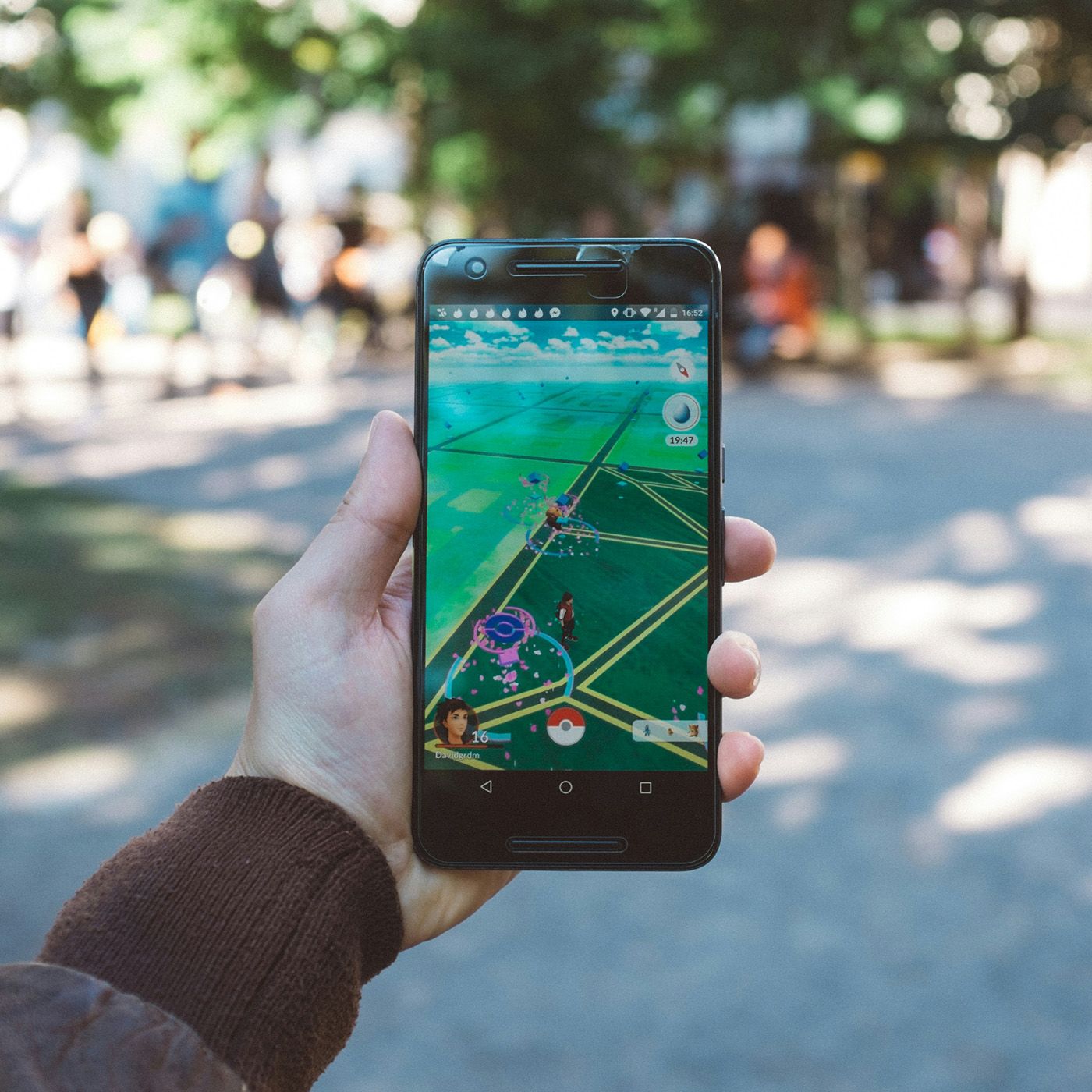 A person playing Pokemon Go during daytime