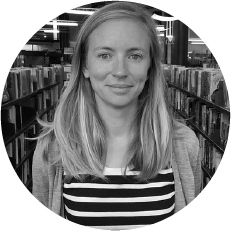 A black and white image of a smiling person.