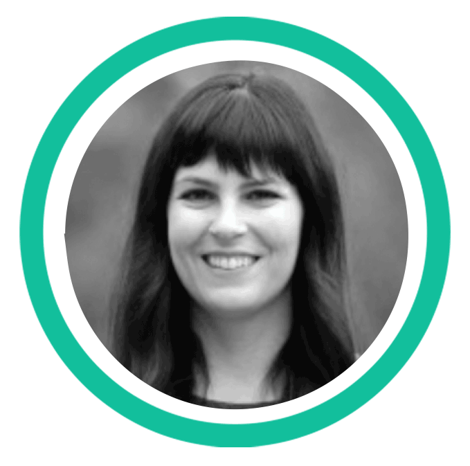 A black and white headshot of a woman with long dark hair and a fringe. 