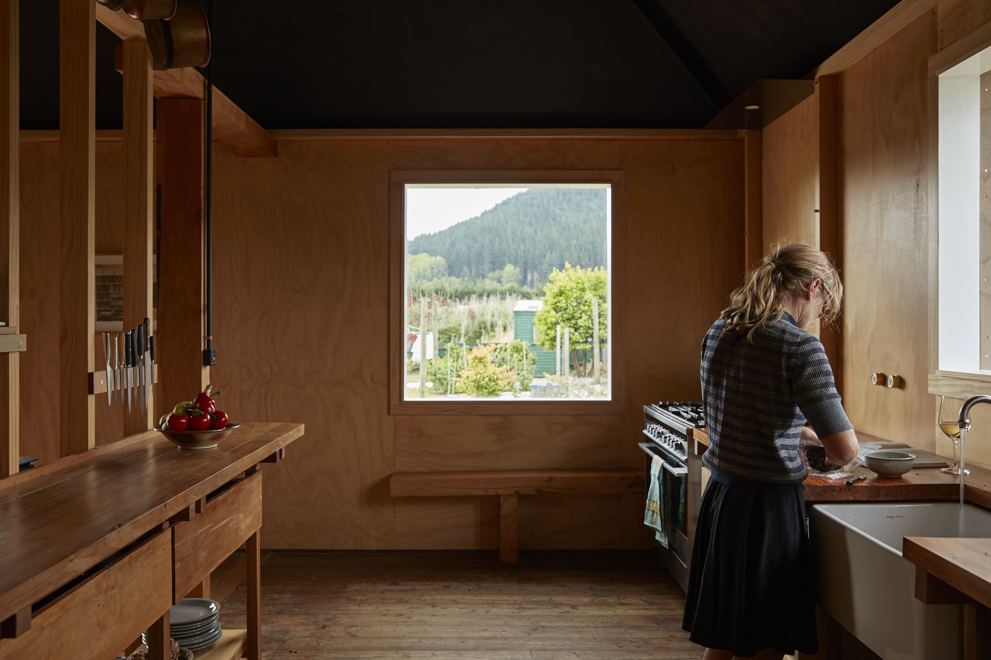 A person standing at a sink washing dishes.