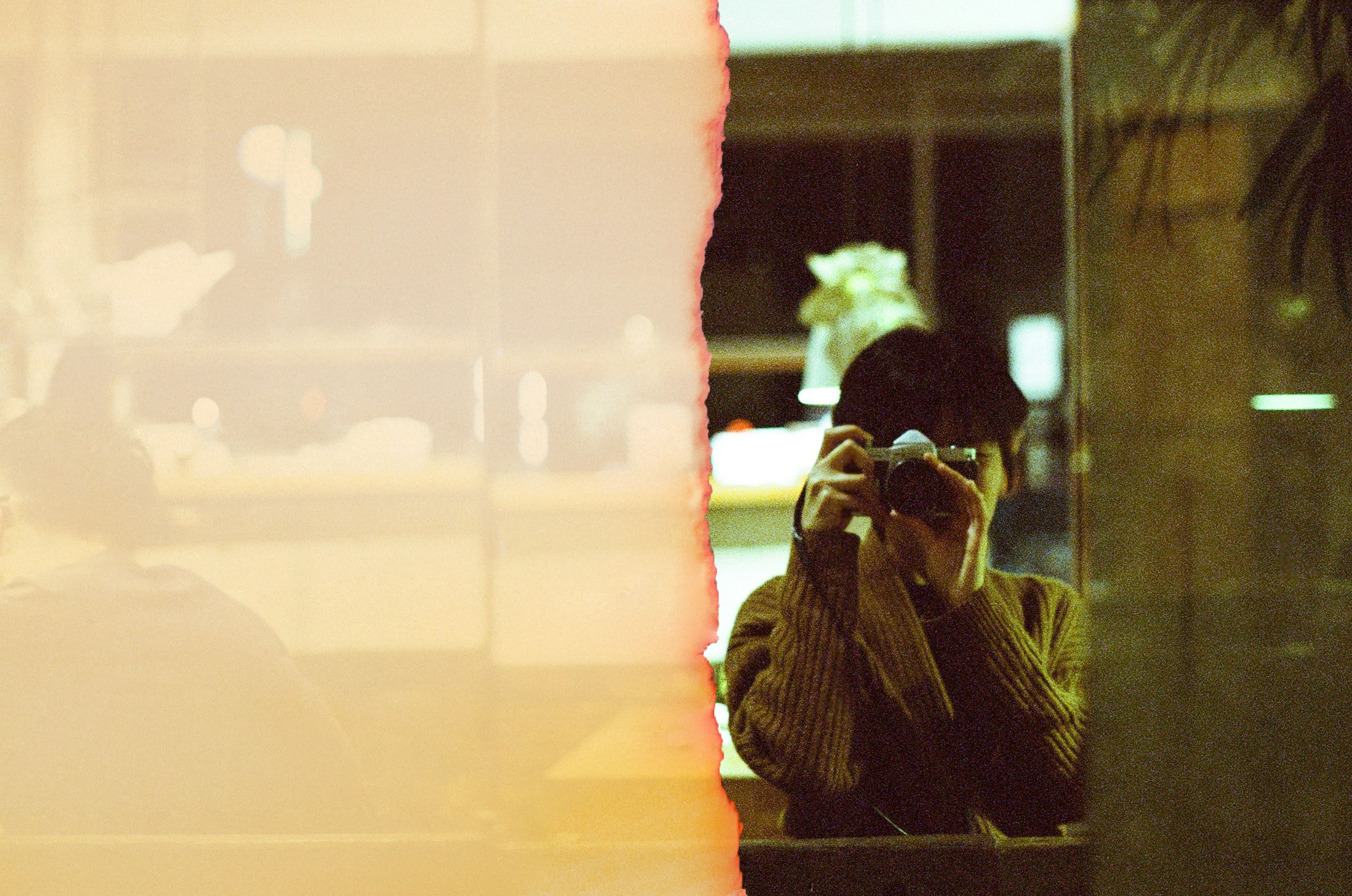 woman in restaurant taking photo of the outside
