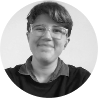 A black-and-white portrait image of a person with short hair and modern glasses.