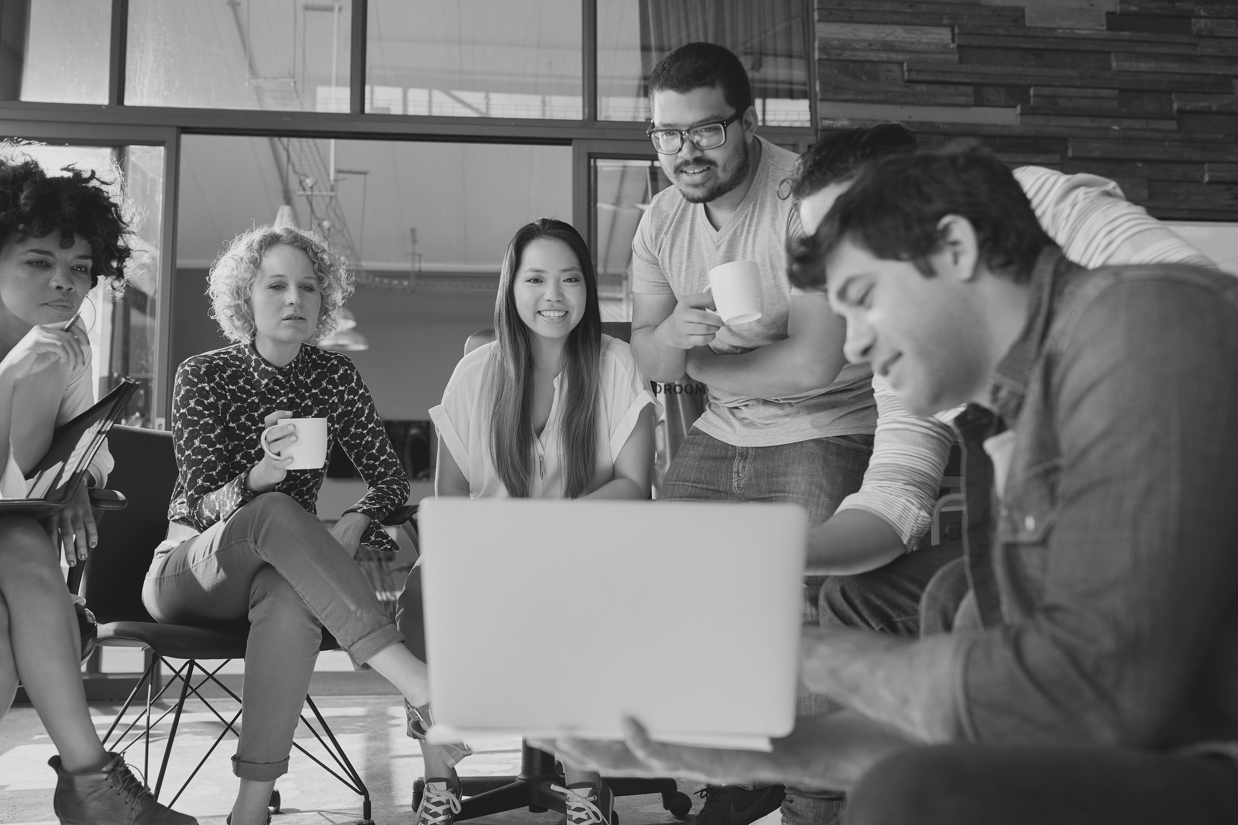 People clustered around a screen, previewing a pitch deck
