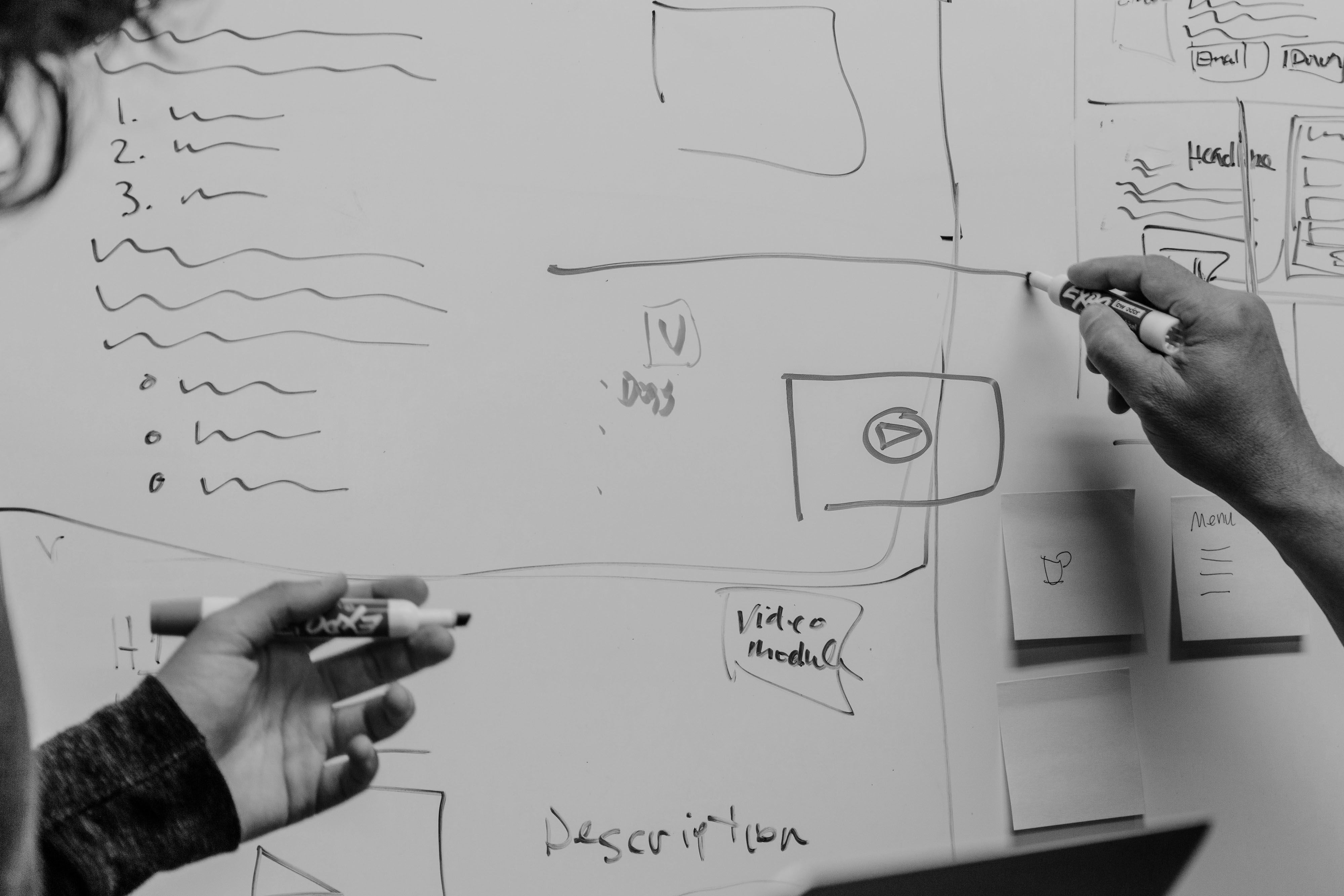 Hand on a whiteboard, fleshing out a pitch deck structure