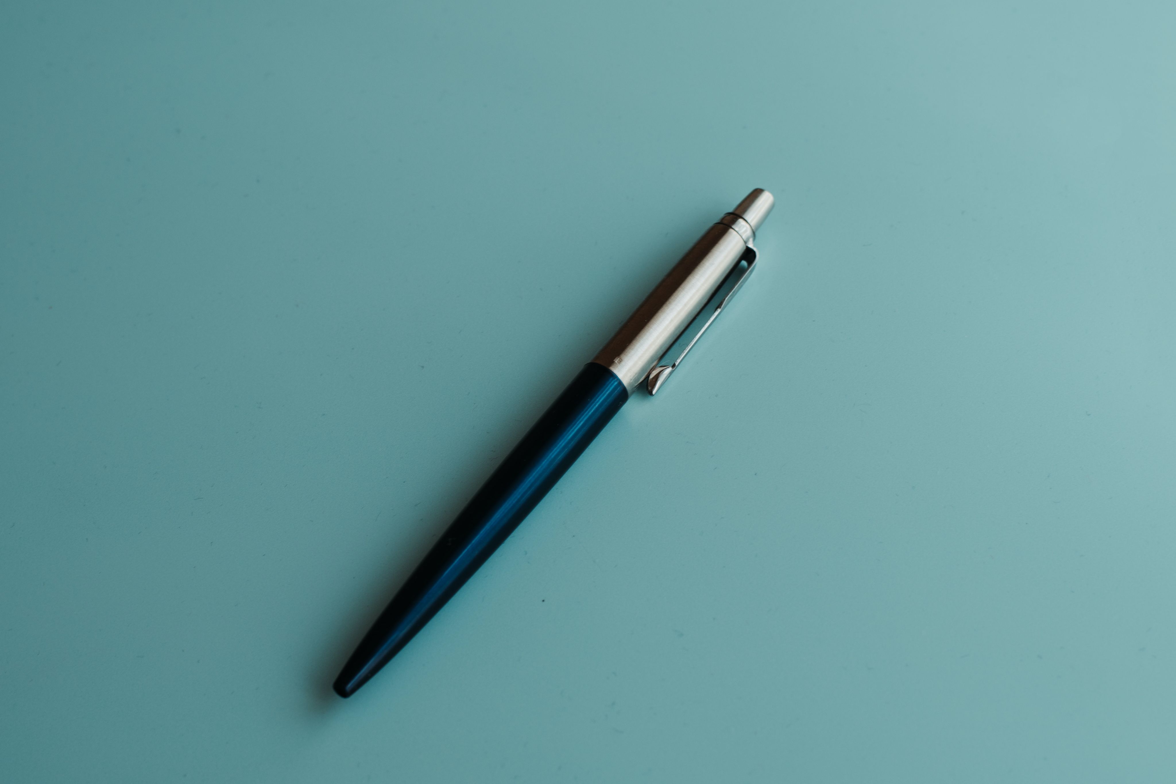 silver and blue click pen
