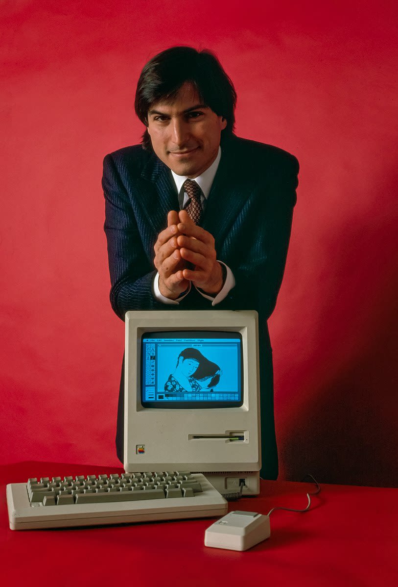 Apple CEO Tim Cook with early Macintosh computer.